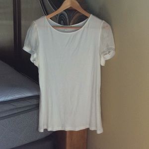 White blouse with sheer puff sleeves.